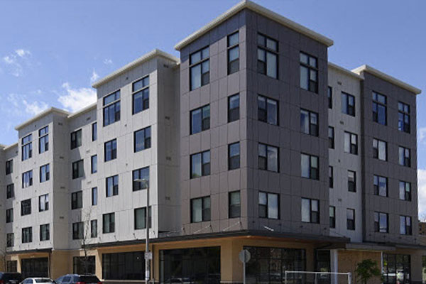 Nuestra Communidad, Roxbury MA, developers of the Bartlett Station, featuring both affordable and market-rate rental and homeownership housing, with a public events plaza, grocery store, shops, and interactive art area.